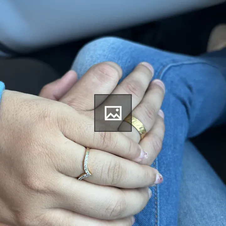 Two intertwined hands with rings