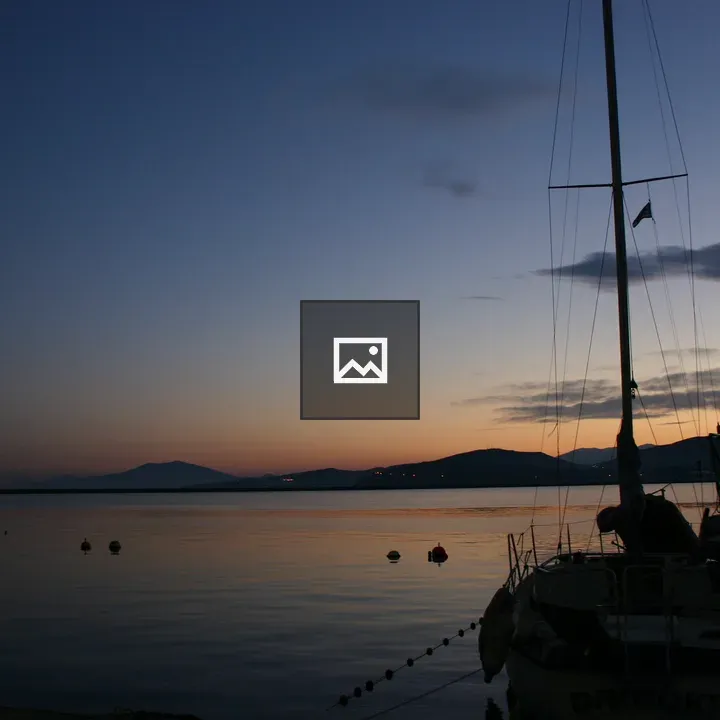 Volos harbor at dusk with boat