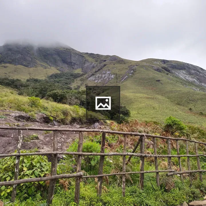Green hill in Rajamala under clouds