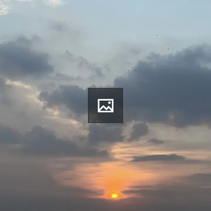 Sunset with glowing sun and clouds