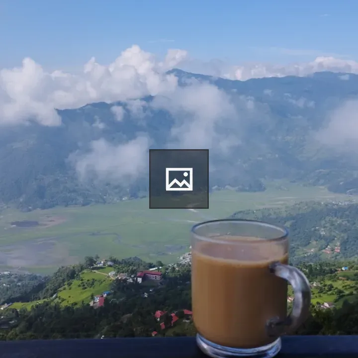 Cup of tea on a rail with valley view