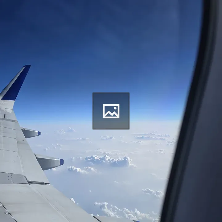 Wing of Airplane in Sky