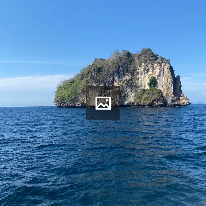 Rock formation above blue sea