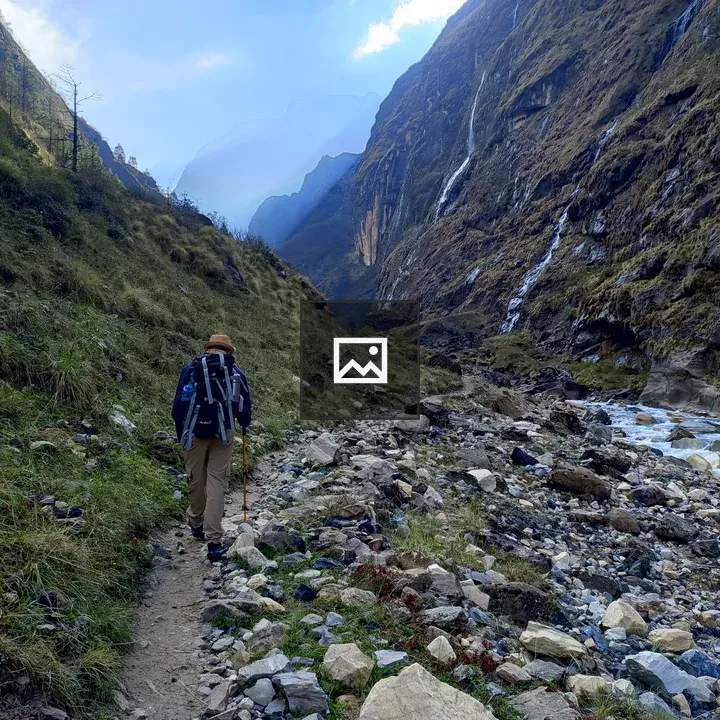 Hiker along rocky mountain path
