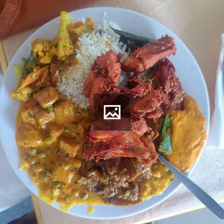 Colorful plate with yellow rice and vegetables