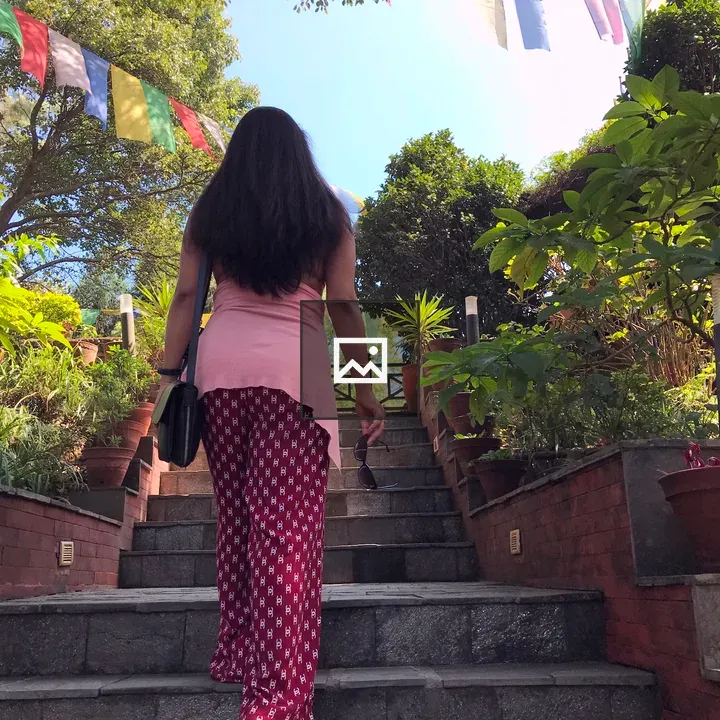 Back view of a woman walking up steps