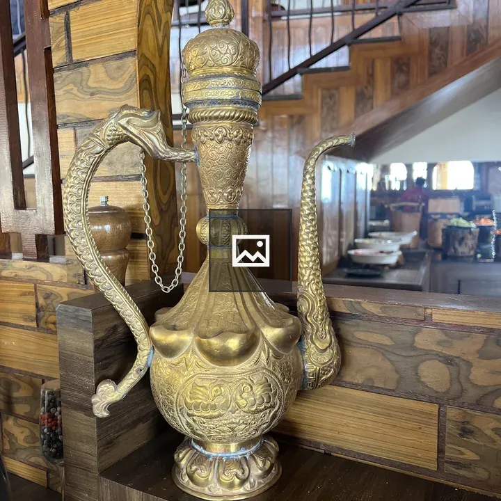Ornate Brass Pitcher on Shelf