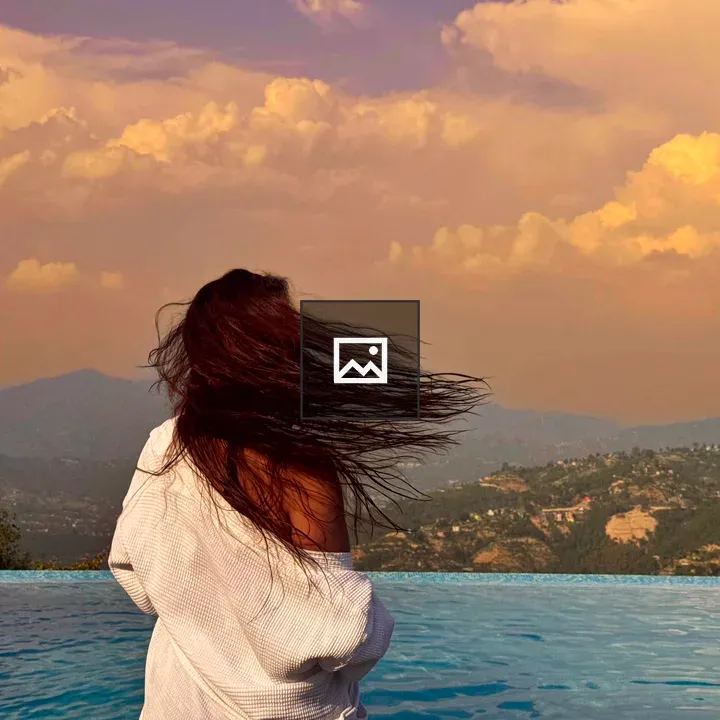 Back view of person by infinity pool