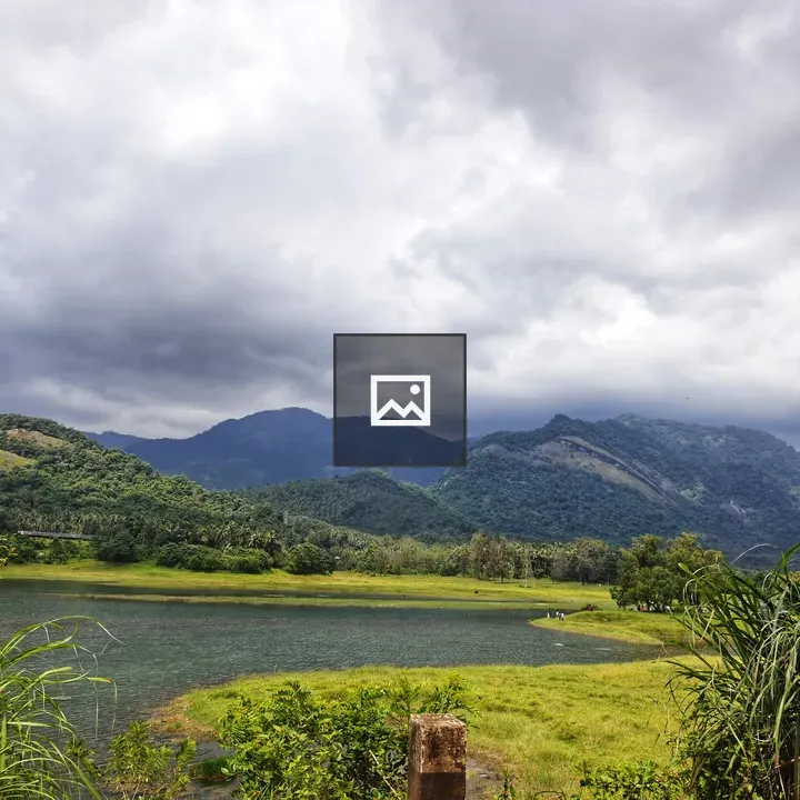 Lush hills and river with cloudy sky