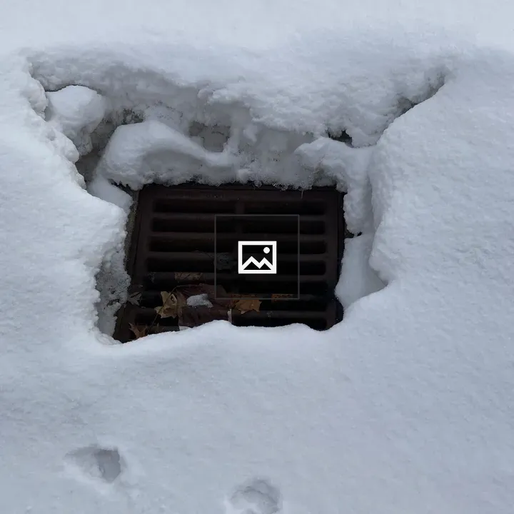 Snowy street water drainage