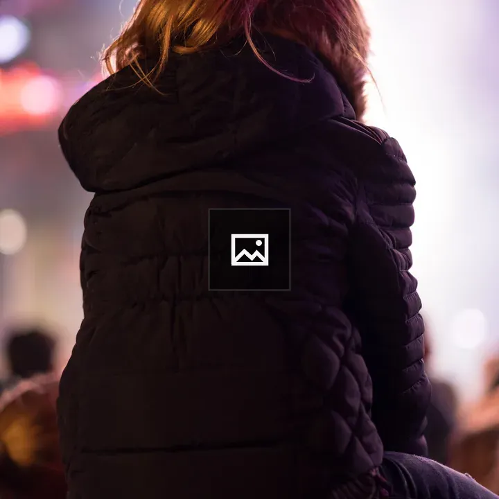 Girl on shoulders at outdoor concert