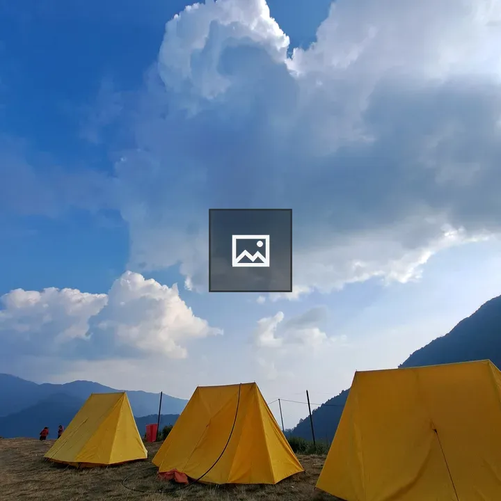 Yellow tents on grassy plain