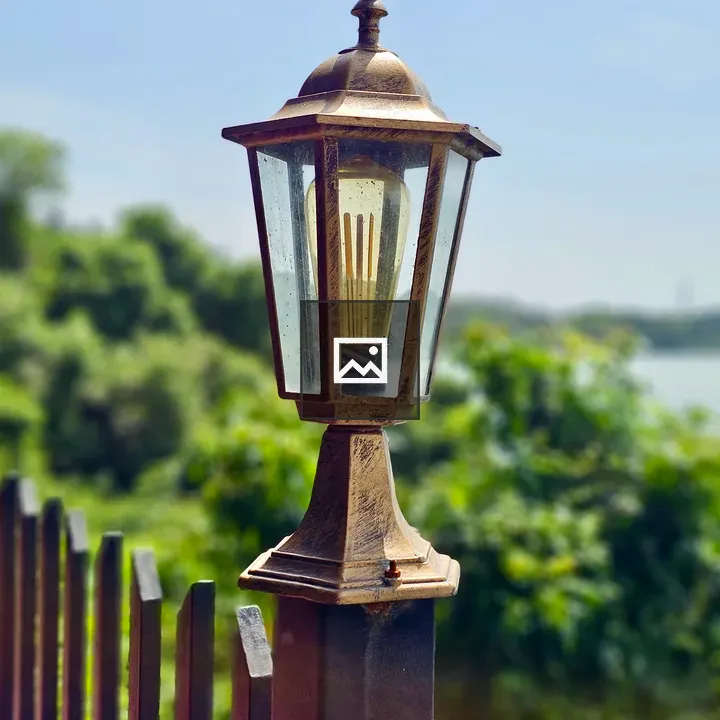 Vintage outdoor lamp on fence post