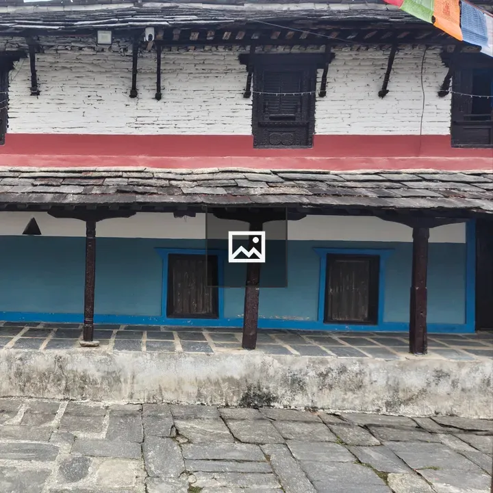 Two-story stone house with colorful walls