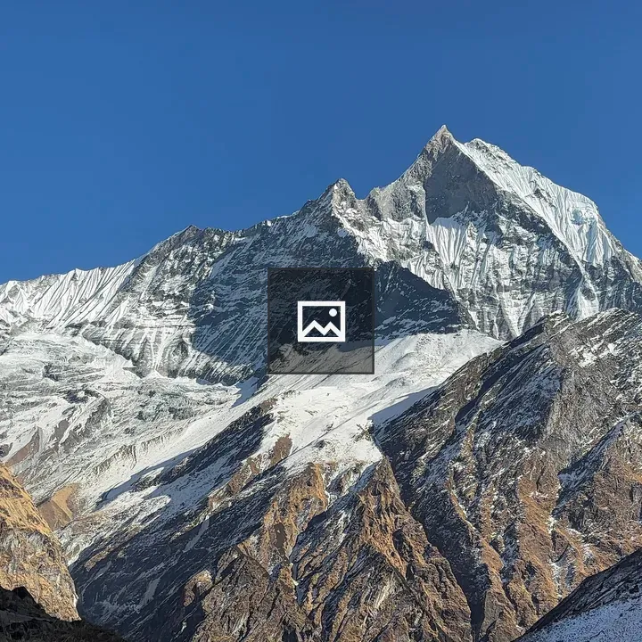 Majestic mountain peak beside blue sky