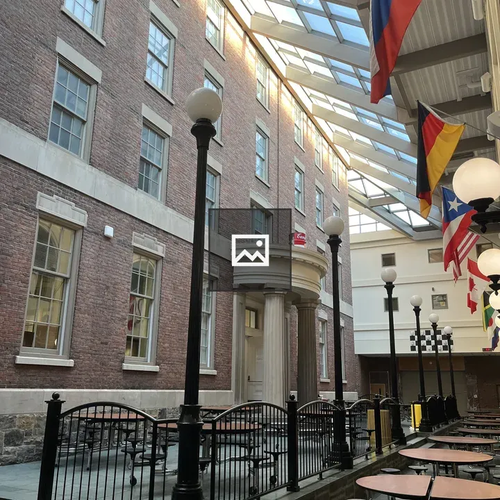 Common area interior with brick wall and glass ceiling