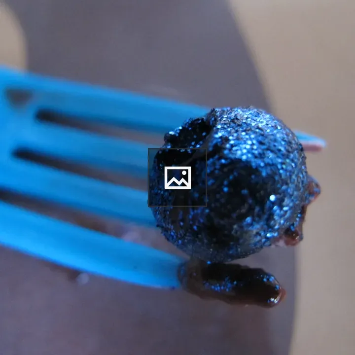 Blue blueberry on a blue fork