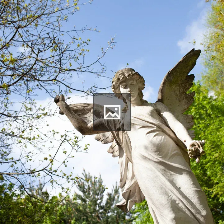 Angel statue with trees