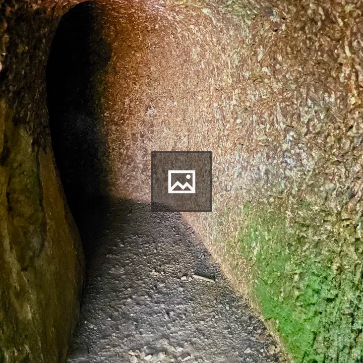 Narrow Curved Stone Tunnel