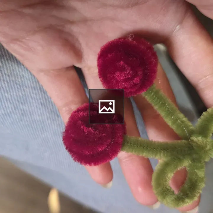 Hand holding pipe cleaner craft