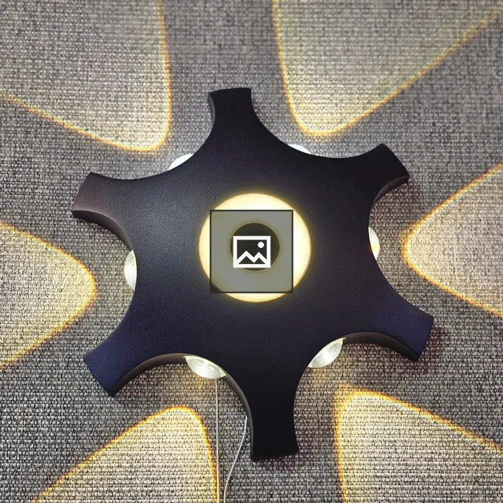 Star-shaped wall lamp on gray wall