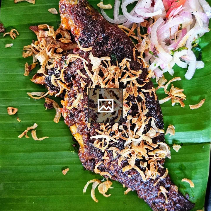 Deep-fried tilapia on banana leaf