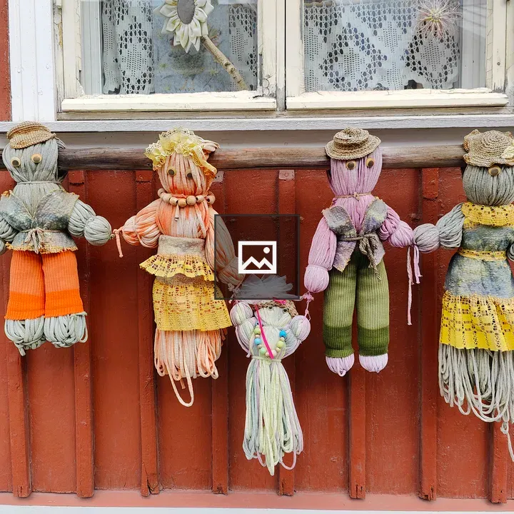 Four handcrafted yarn dolls