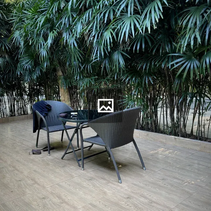 Two wicker chairs and glass table on deck