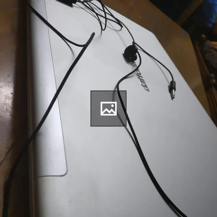 Tangled Earphones on Laptop Lid