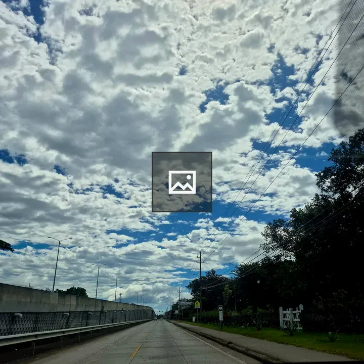 Long open road under dramatic sky