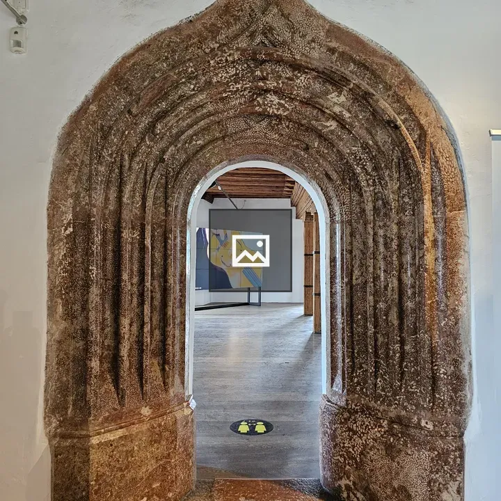 Arched doorway with art in white wall