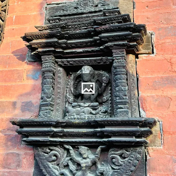 Wooden relief deity with floral carvings