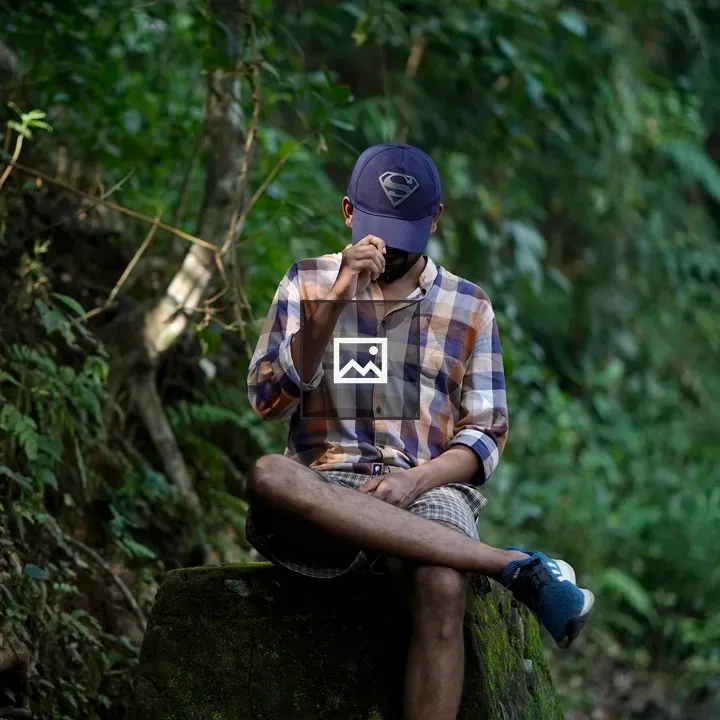Man with hat in plaid shirt