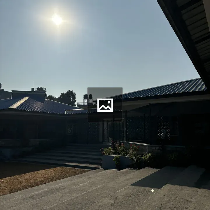 Sunlit walkway toward modern roof
