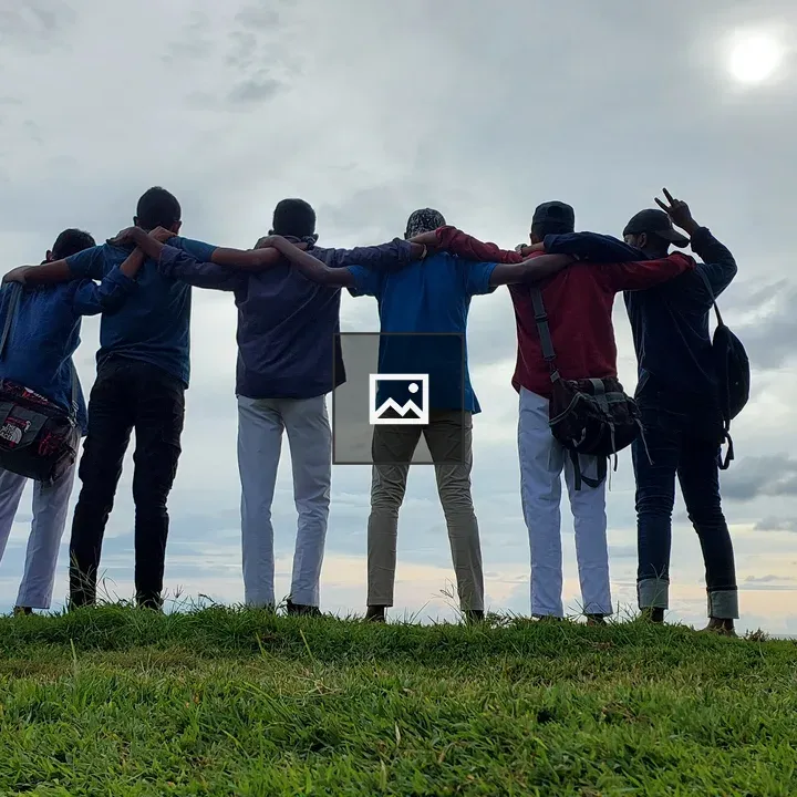 Six young men on grassy hill