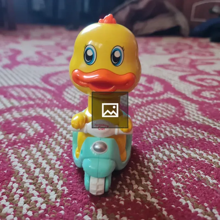 Yellow toy duck on blue motorcycle