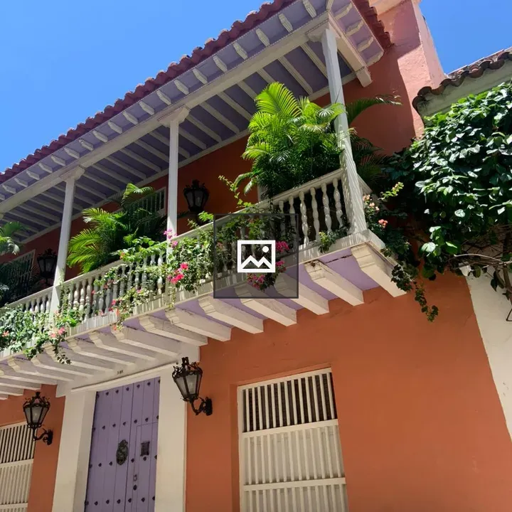 Salmon-Colored Colonial Building with White Balcony