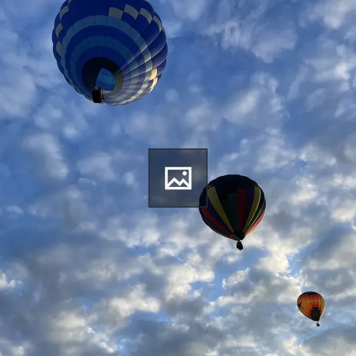 Hot air balloons in cloudy sky