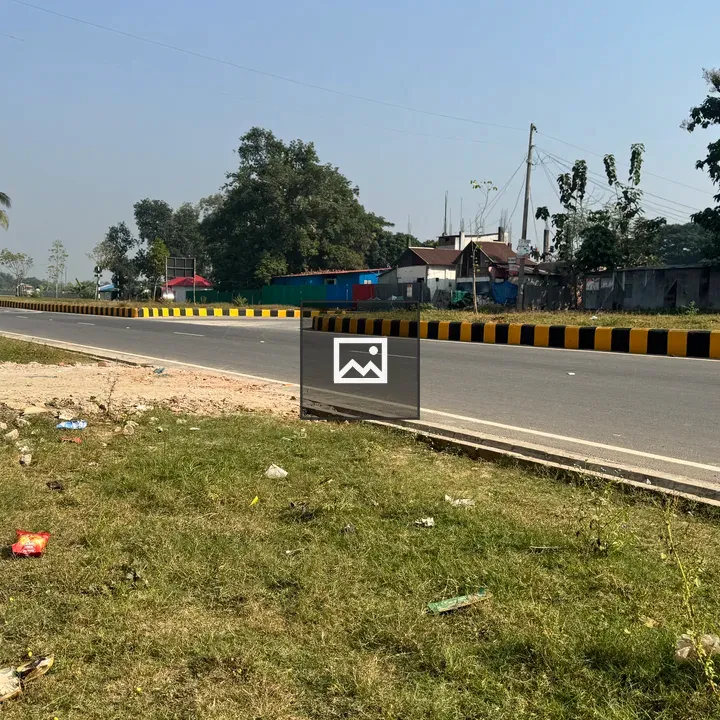Road alongside tiled sidewalk and grassy patch