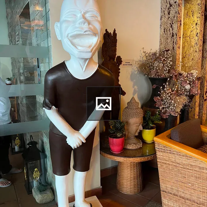 White Laughing Statue indoors