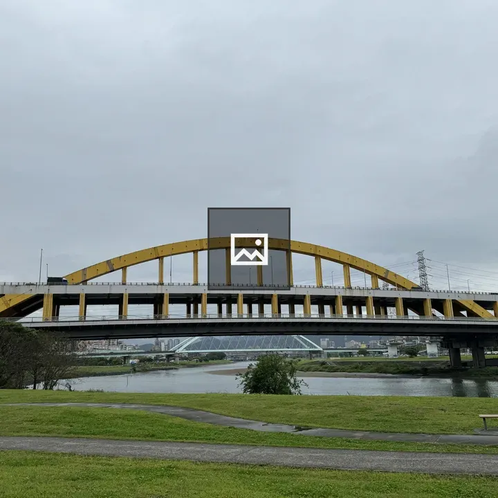 Yellow arch bridge over river