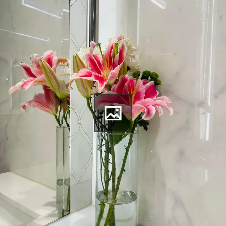 Glass vase with pink lilies