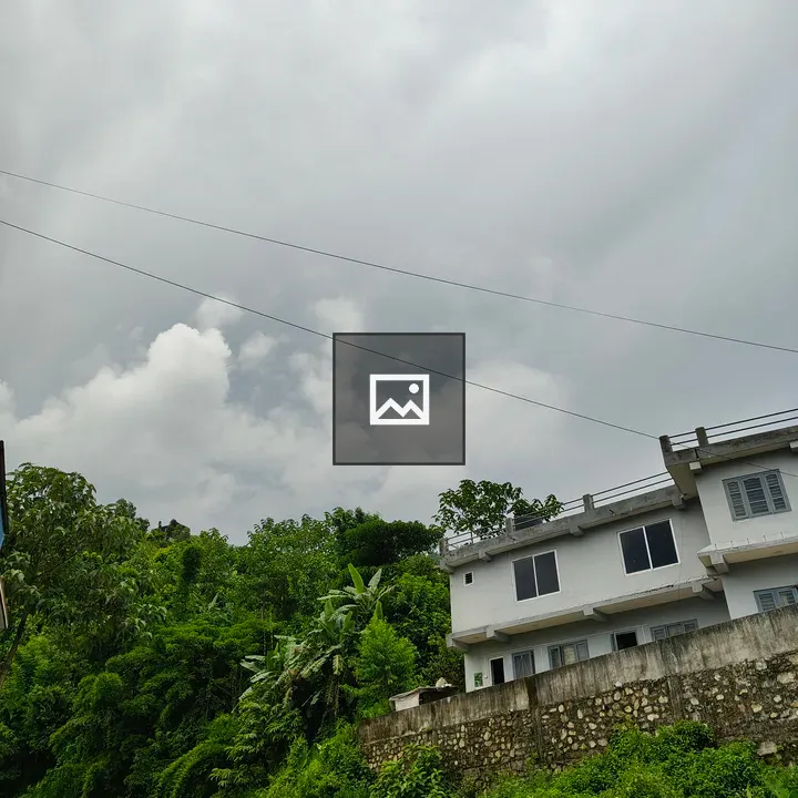 White House beside lush hillside