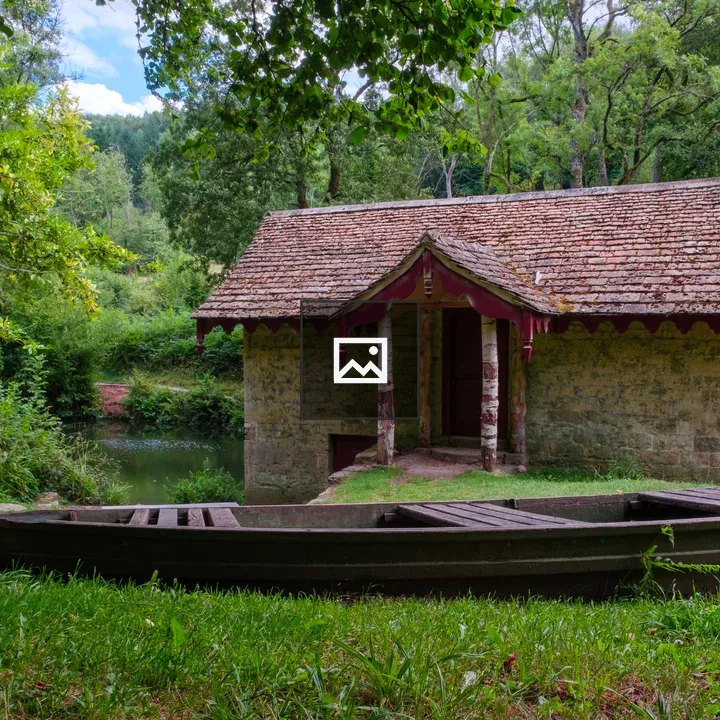 Wooden Boat by Boathouse