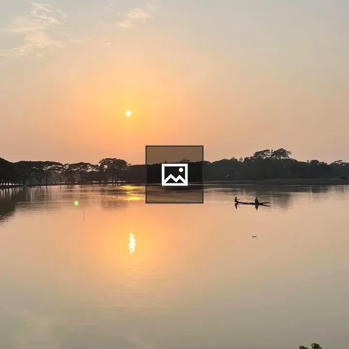 Sunset Over Lake with Canoe