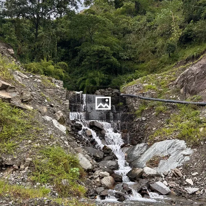 Waterfall over rocks in lush greenery
