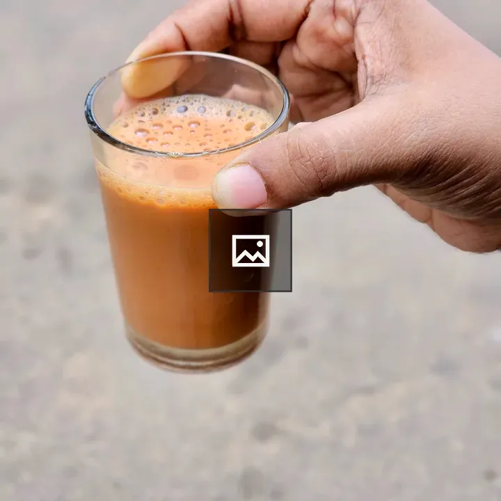Glass of hot tea in hand