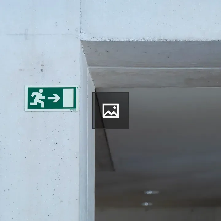 Green Emergency Exit Sign on Wall