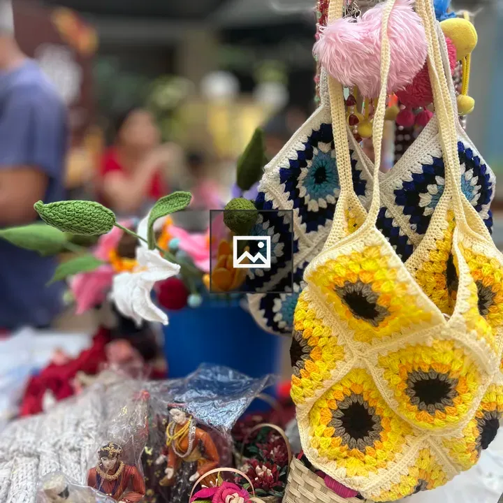 Crocheted sunflower bags at market stall