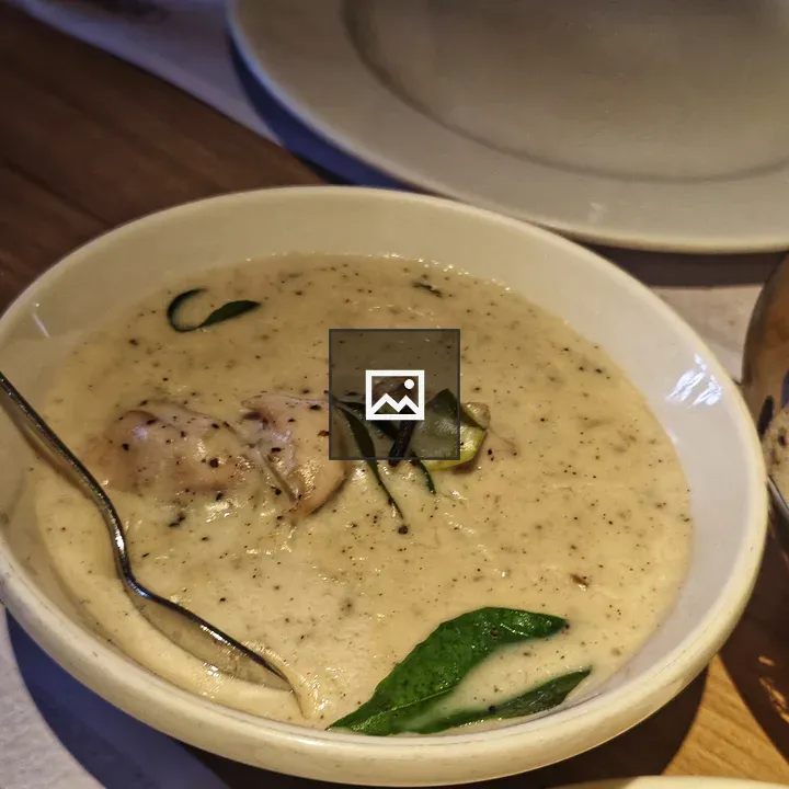 Creamy soup in white bowl
